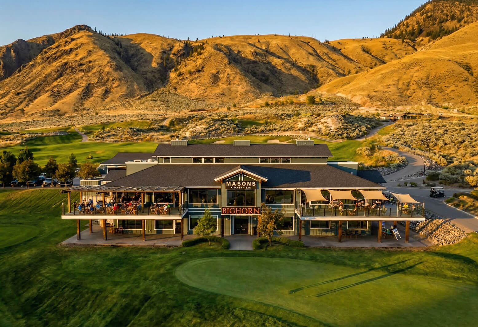 Bighorn Golf clubhouse and Masonâ€™s Kitchen & Bar patio with mountain views in Kamloops