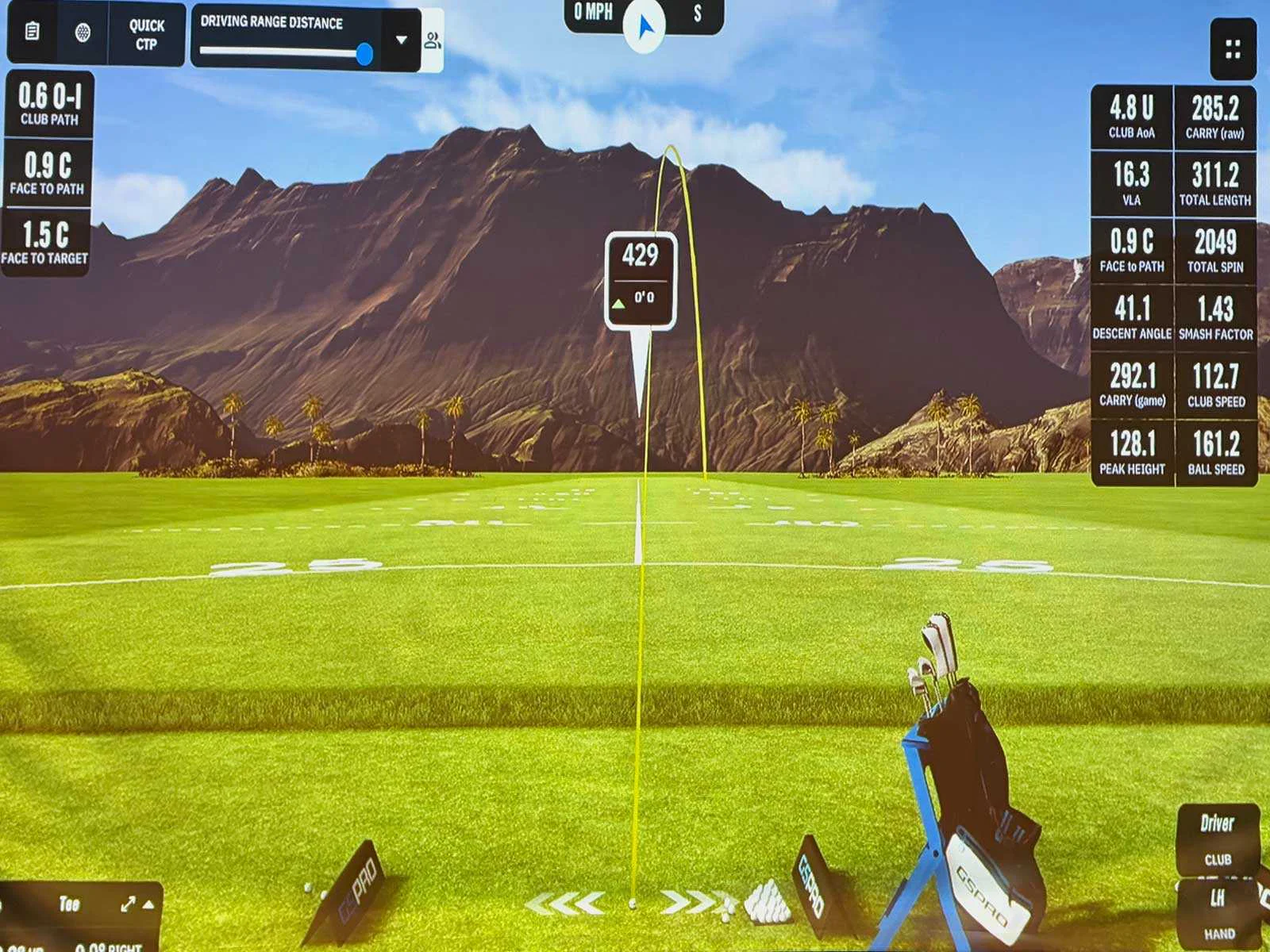 Golf simulator screen showing shot tracking data, ball flight path, and driving range metrics